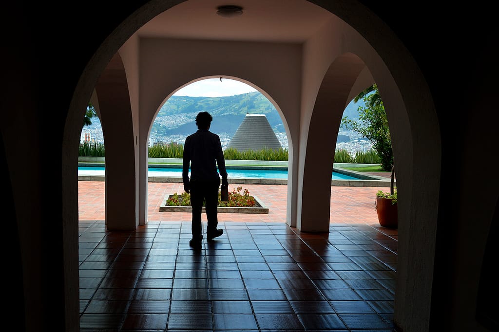 A man stands under an arch at the Guayasamin Museum in Quito