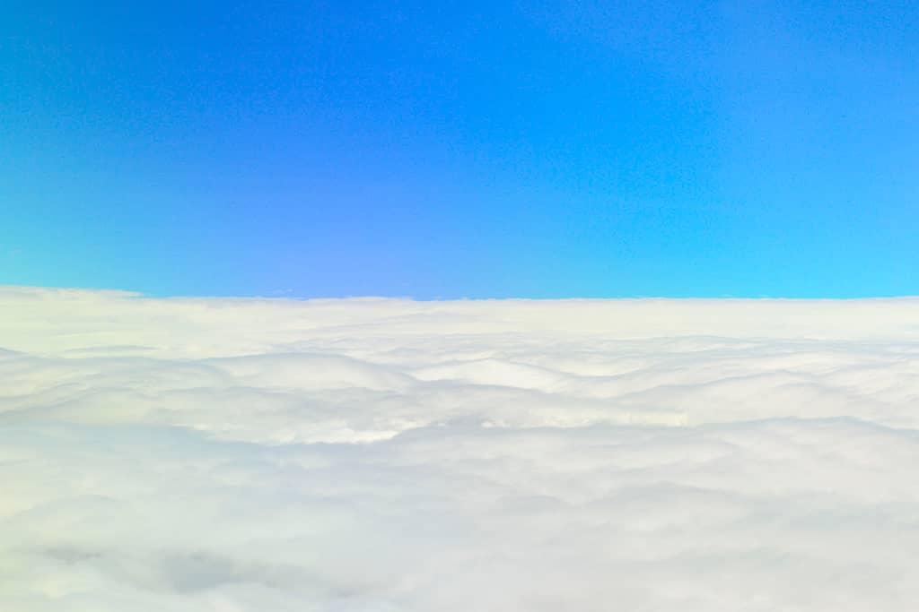 Image of a sea of clouds from outside of an airplane window
