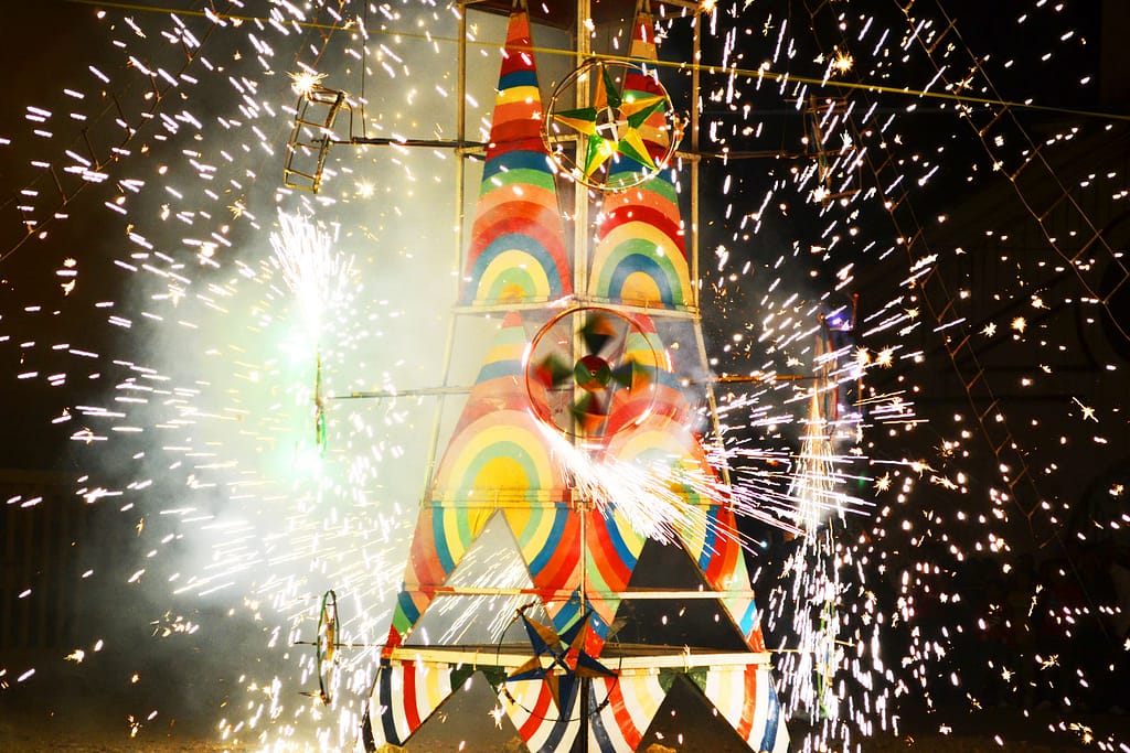 Fireworks rotate on a colorful metal "castillo" in Ecuador
