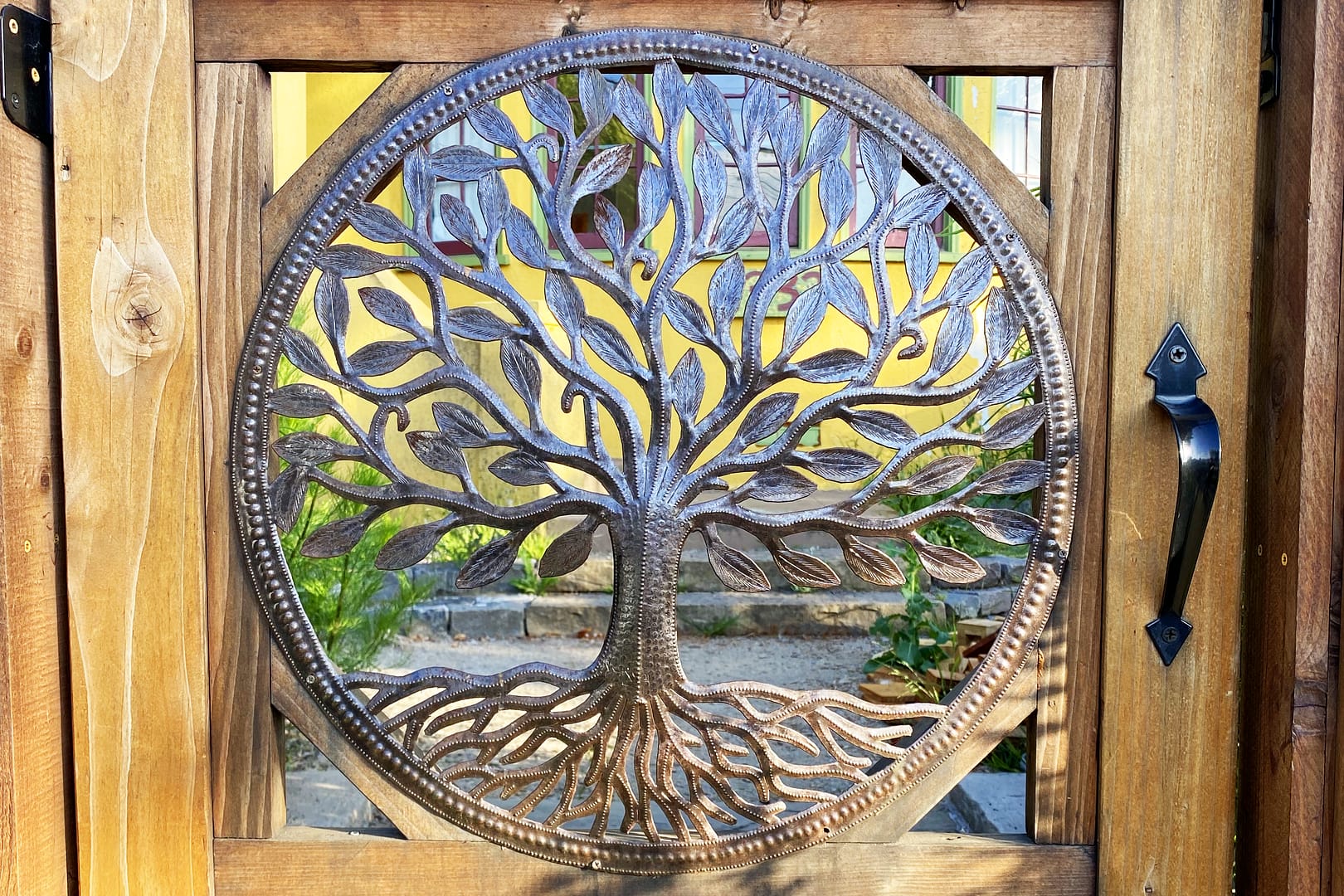 A depiction of the Tree of Life in metal inlaid in a wooden doorway
