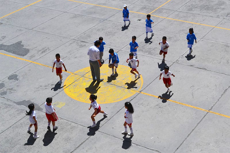 Children play soccer on a playground near Quito, Ecuador