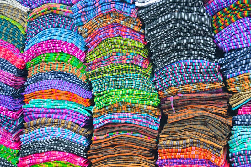 Piles of brightly-colored cloth in Otovalo, Ecuador